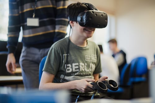Student using a VR headset to test a game they built in Digital Games.