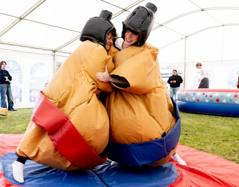 6th-Form - Highlands Fete 2024 - Two Students Sumo Wrestling at a Celebration Event