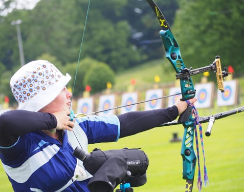 Mollie Perrett Shooting a Bow in a Competition